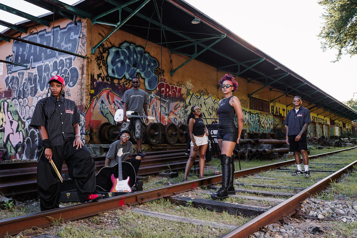 Models wearing the collection against a graffiti covered backdrop